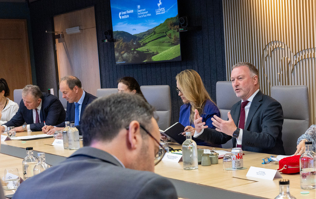 Environment Secretary Steve Reed sits at a table with green finance stakeholders.
