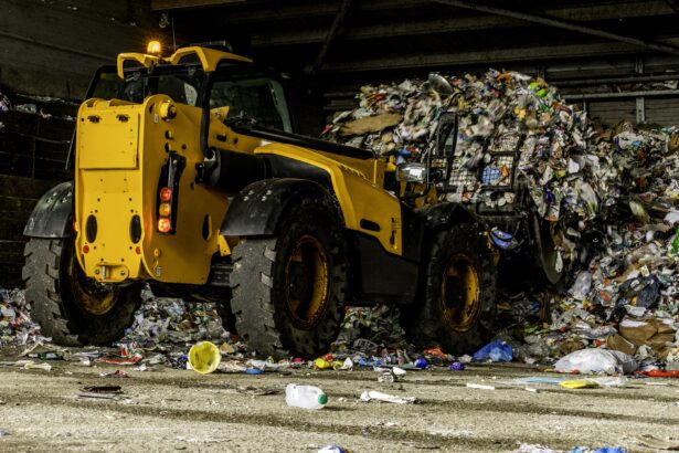 A low level shot of a telehandler collecting recycling to put into a lorry for transportation